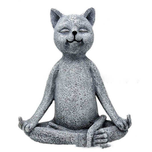 Concrete cat statue in a meditative pose on a white background